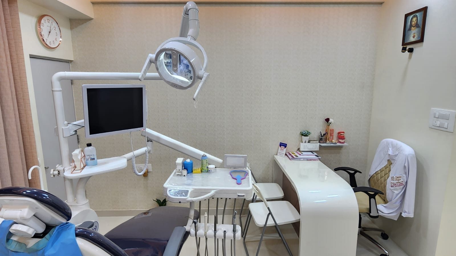 Treatment room at Smile Align with a dental chair, overhead light and monitor